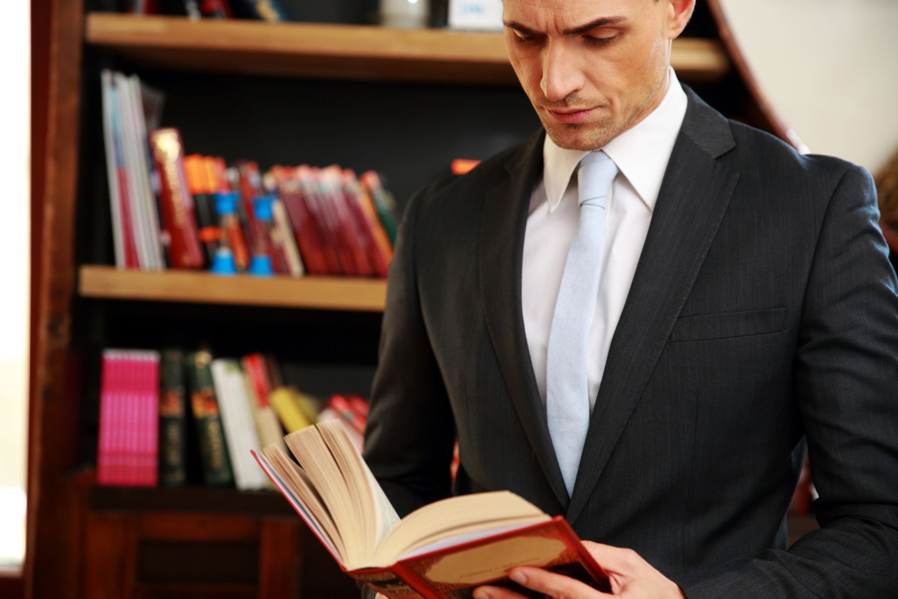 Businessman reading the book in library